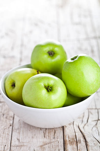 istock ripe green apples in bowl 480366895