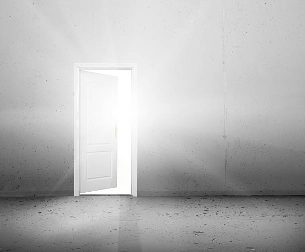 istock Open door to a better world, light shining through doorway 480367433