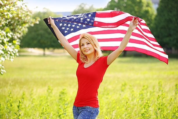 istock Beautiful patriotic young woman with American flag 480367708