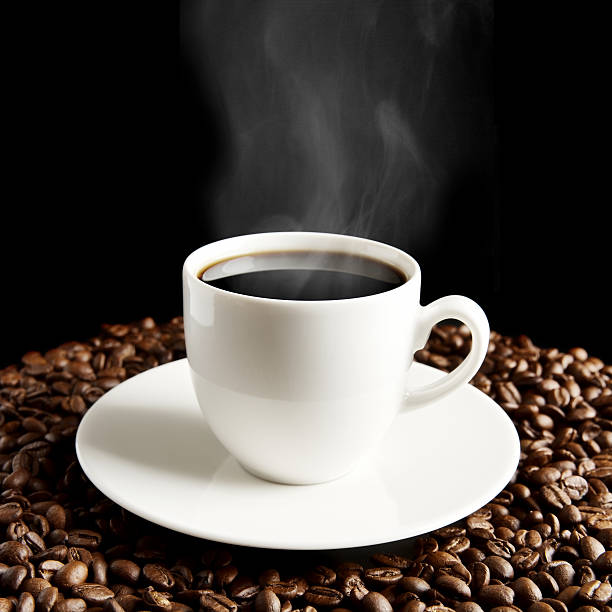 istock Cup of coffee with haze and coffee beans on black 480368122