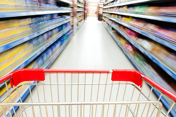 istock Supermarket interior, empty red shopping cart. 480368181