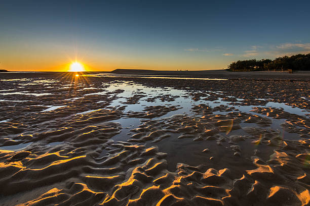 istock sunrise over coastal lake at low tide 480369616
