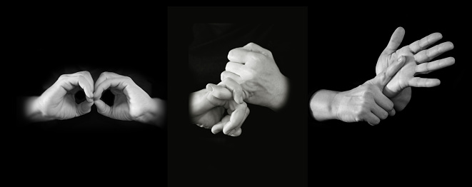 Communicator's hands spelling out BSL in British sign language. 3 sets of hands spelling out the letters B, S and L in official British sign language. Black and white.