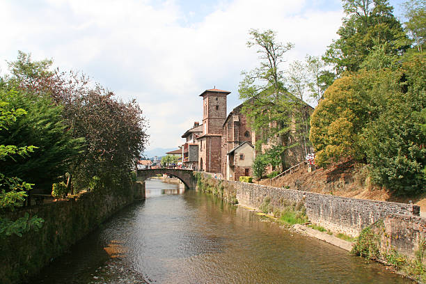 Church of Saint Jean Pied de Port, Pyrenees Atlantiques, France Church of Saint Jean Pied de Port overlooking Nive river, Basque country. saint jean pied de port stock pictures, royalty-free photos & images