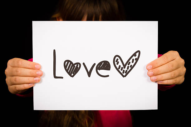 istock Child holding Love sign 480370636