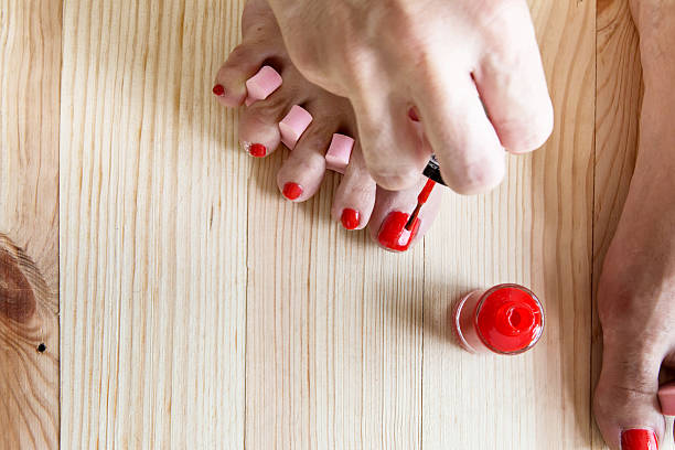 istock Woman painting toe nails 480370840