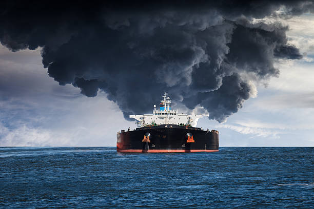 Burning ship Burning Tanker ship on the sea. oil tanker stock pictures, royalty-free photos & images