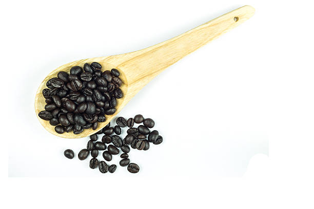 istock Coffee beans in wooden spoon isolated on white 480374500