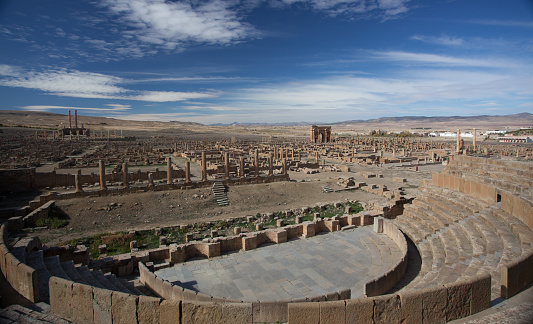 blue sky and white clouds on the Roman ruins of Timgad in Algeria, World Heritage Site by UNESCO