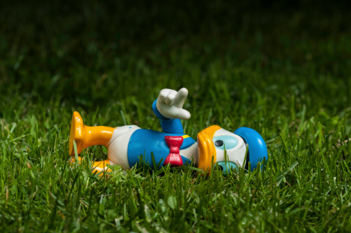 Lahti, Finland - June 15, 2013: Donald Duck lying on grass