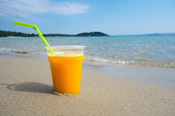 istock Orange Juice against sea landscape 480379684