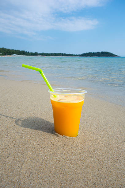 istock Orange Juice against sea landscape 480379686
