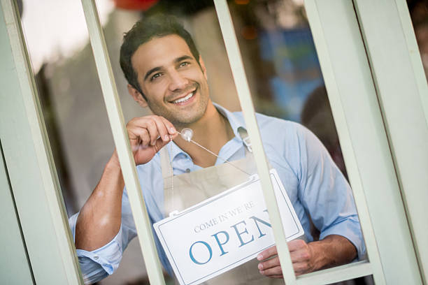 istock Man hanging an open sign on his Business door 480379794