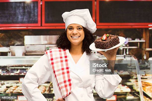 Baker Carrying Cake At Bakery Shop Stock Photo - Download Image Now - 20-29 Years, 2015, 25-29 Years