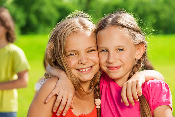 istock Two happy girls hugging 480380189