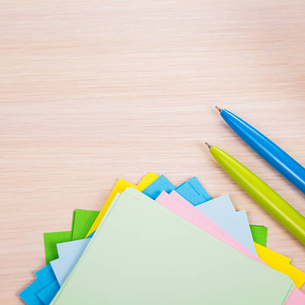 istock pen and paper on wooden background 480381344