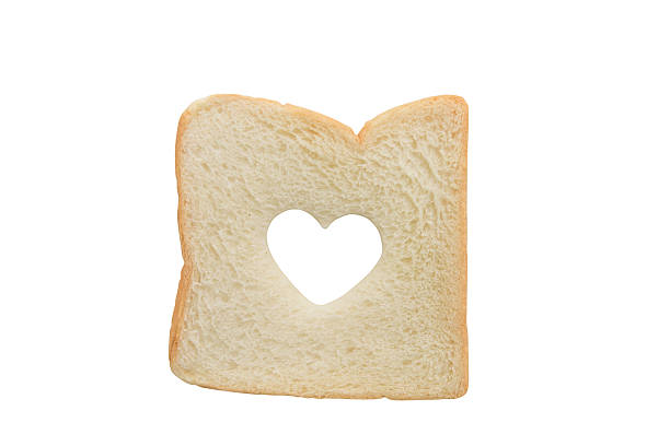 istock Heart shaped hole in a slice of bread isolated 480381758