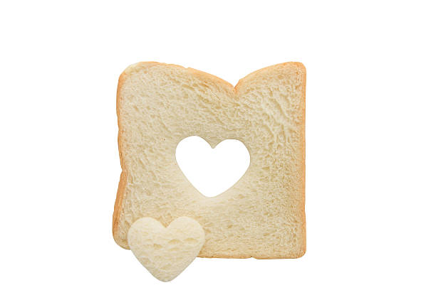 istock Heart shaped hole in a slice of bread isolated 480381762