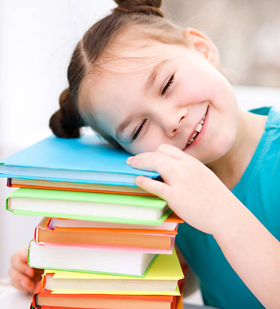 istock Little girl is reading a book 480390115