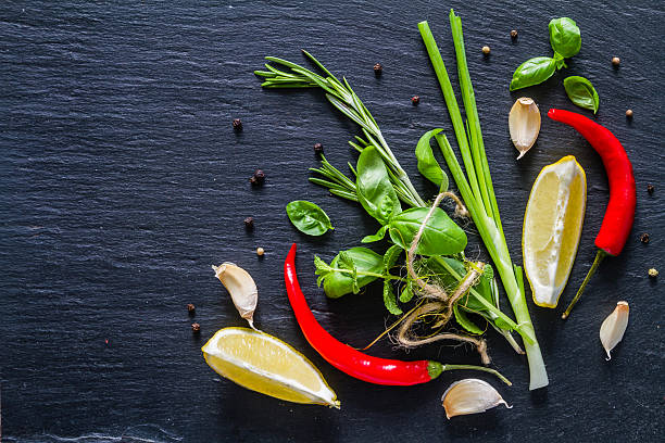 istock Selection of herbs and spices, dark stone background 480391178