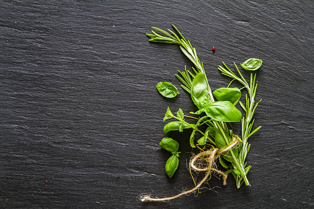 istock Selection of herbs and spices, dark stone background 480391192