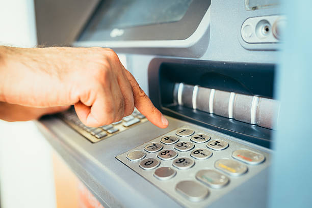 istock Man Withdraws Money From An Atm 480391314