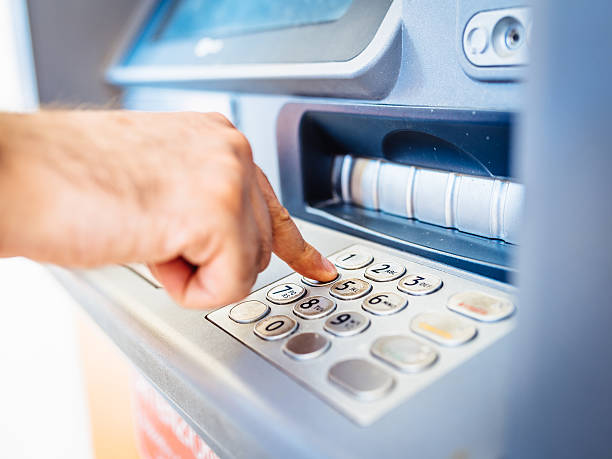 istock Man Withdraws Money From An Atm 480391388