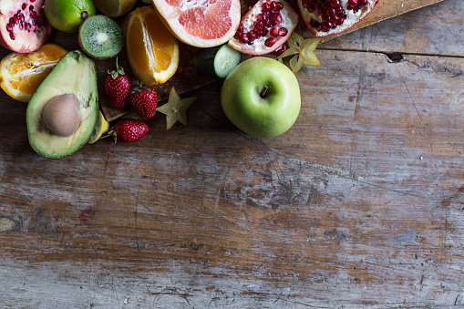 Healthy eating background of different fruits on old wooden table
