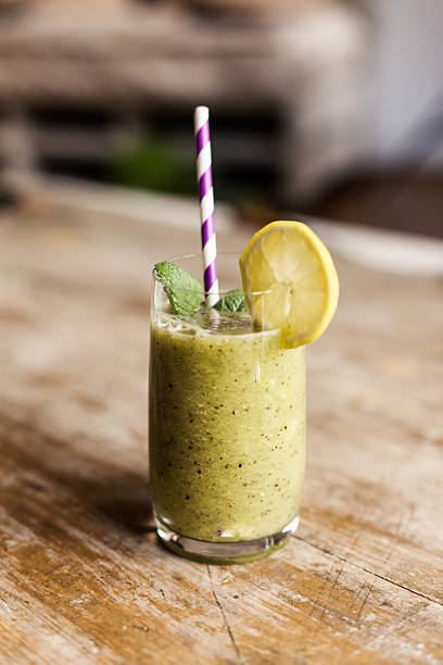 istock Blended smoothie with ingredients and purple striped colored straws. 480393372