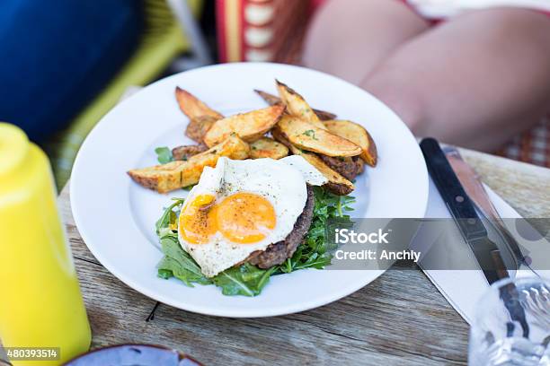 Grilled Steaks French Fries Fried Egg And Vegetables Stock Photo - Download Image Now