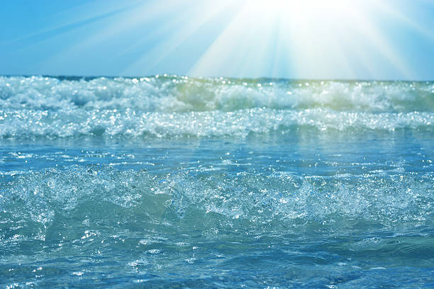 Waves and sun, azure sea. Natural summer background with copy space