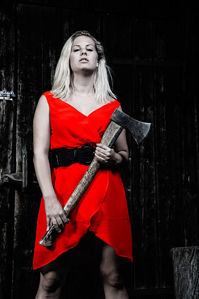 istock woman with axe in a dark environment 480395319
