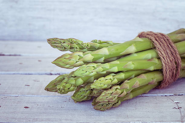 istock asparagus on wooden table with filter effect retro vintage style 480396292