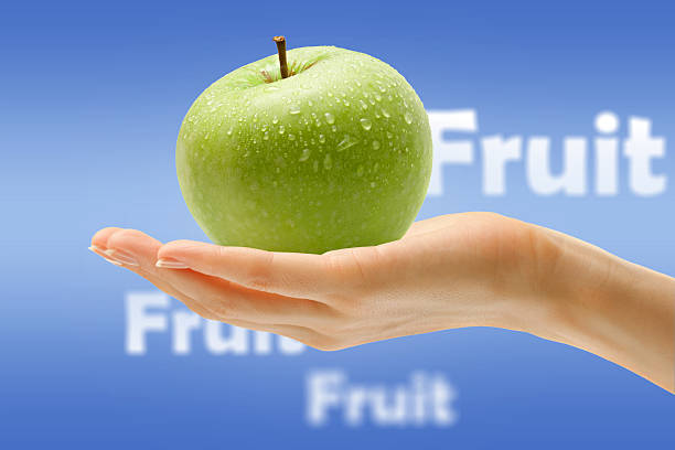 istock Female hand with green apple 480396408
