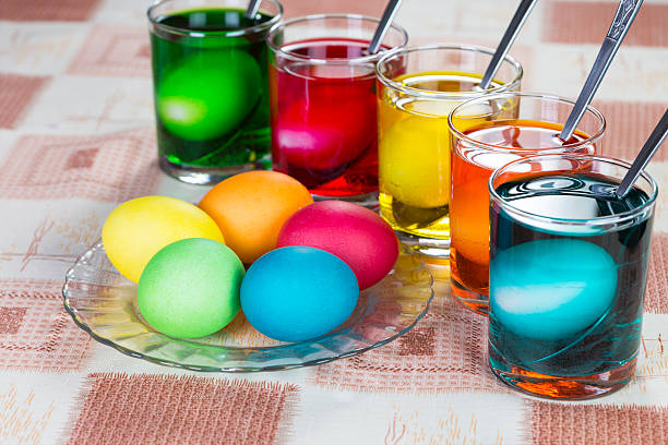 Coloring eggs for Easter holiday Coloring eggs in bright colors for Easter holiday easter egg coloring stock pictures, royalty-free photos & images