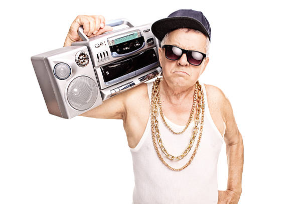 Serious senior rapper holding a ghetto blaster Serious senior rapper holding a ghetto blaster over his shoulder and looking at the camera isolated on white background gangster rap stock pictures, royalty-free photos & images