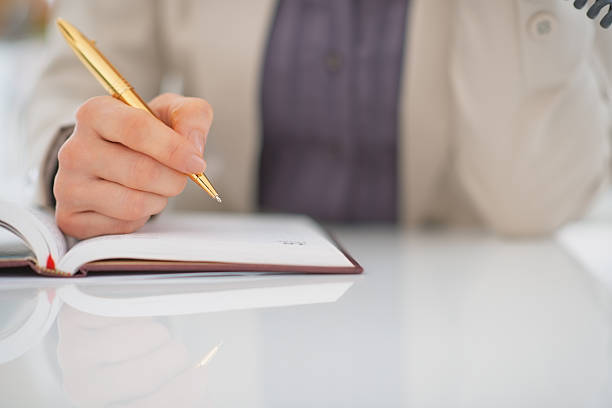istock closeup on business woman writing in diary 480400897