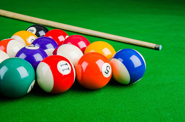 istock Billiard balls on green table with billiard cue. 480401316
