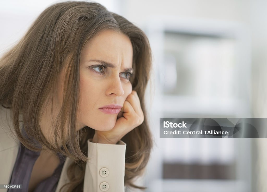 portrait of frustrated business woman sitting in office Portrait of frustrated business woman sitting in office Adult Stock Photo