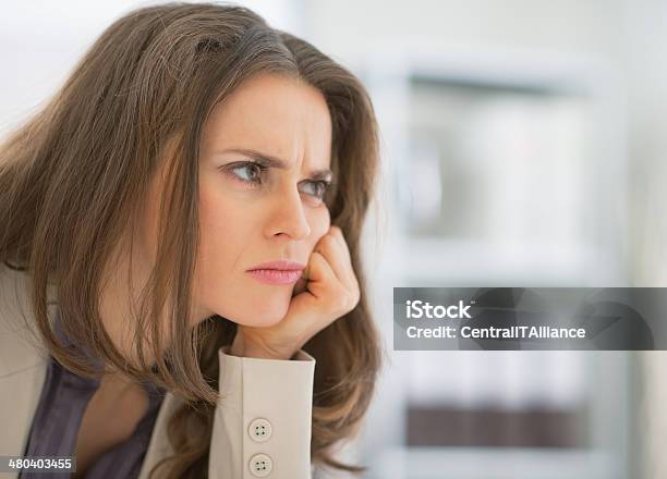 Portrait Of Frustrated Business Woman Sitting In Office Stock Photo - Download Image Now