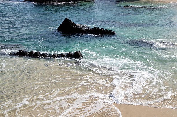 istock Volcanic rocks in the ocean 480403722