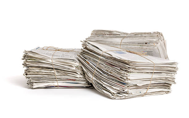 istock Three bundles of newspapers on a white background 480403960