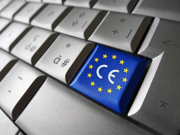 European Union and EU community CE marking concept with sign, symbol and EU flag on a computer key.