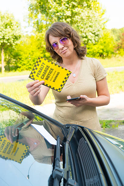 istock woman holding parking ticket 480408006