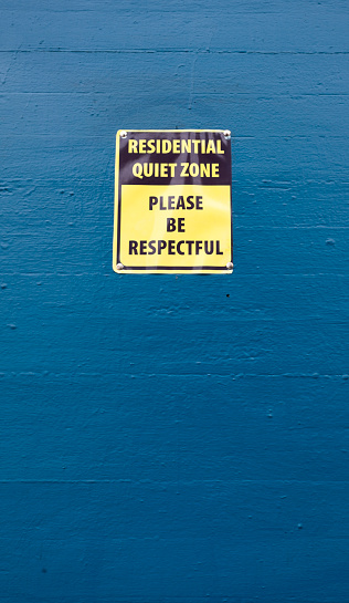 RESIDENTIAL QUIET ZONE sign on blue wall. Shh... Vertical.