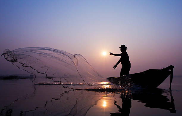 istock Fishermen are catching fish with a cast net. 480408623