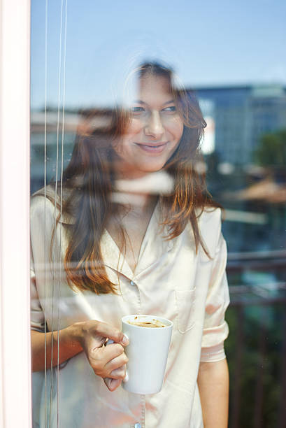 Beautiful young woman having her morning coffee stock photo