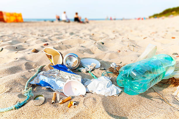 Garbage on a beach left by tourist at sunset. Garbage on a beach left by tourist at sunset, environmental pollution concept picture, baltic Sea coast, Dziwnowek in Poland. littering stock pictures, royalty-free photos & images