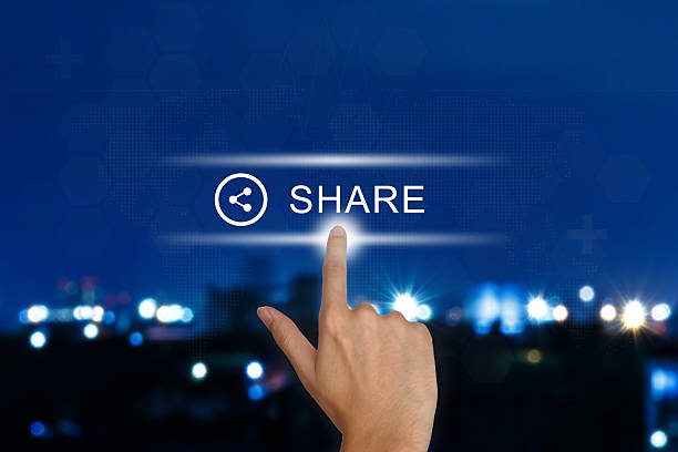 hand pushing share button on touch screen stock photo