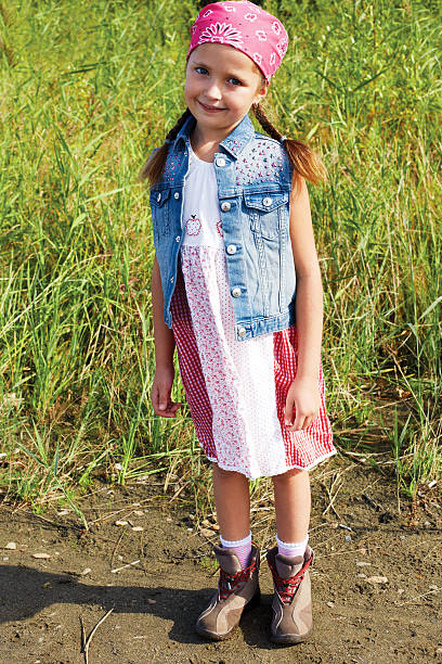 istock Little American girl standing in a cornfield 480419890